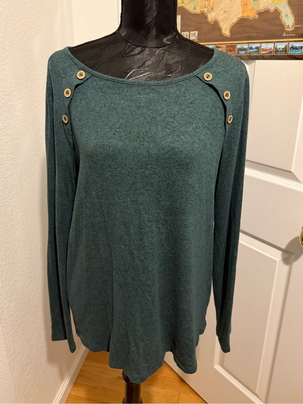 blue long sleeve wide neck shirt with buttons and brown elbow decoration